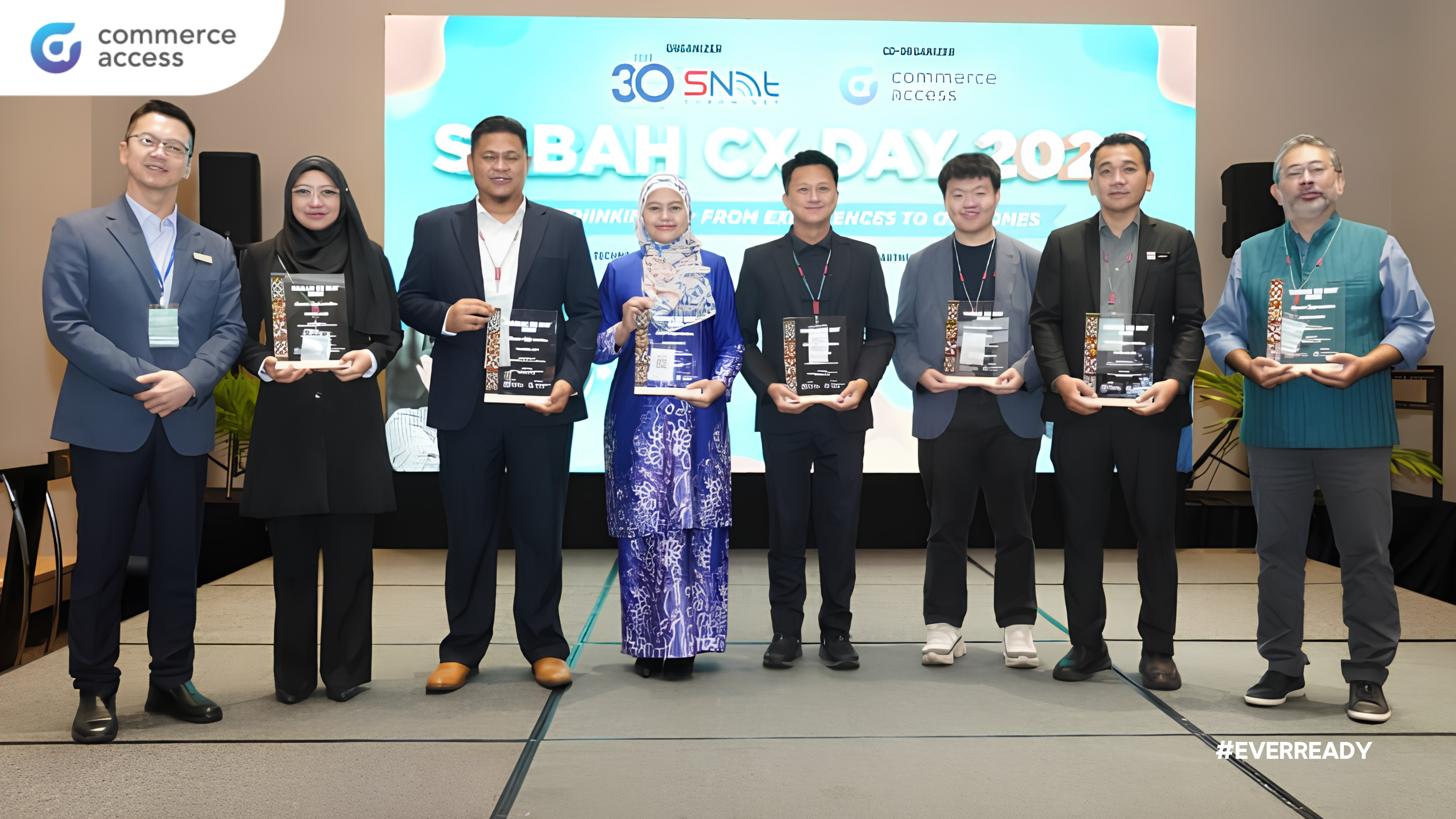 CASB leaders and industry participants at Sabah CX Day 2026 holding awards on stage